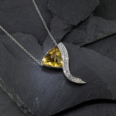 A silver Necklace with large yellow jewel